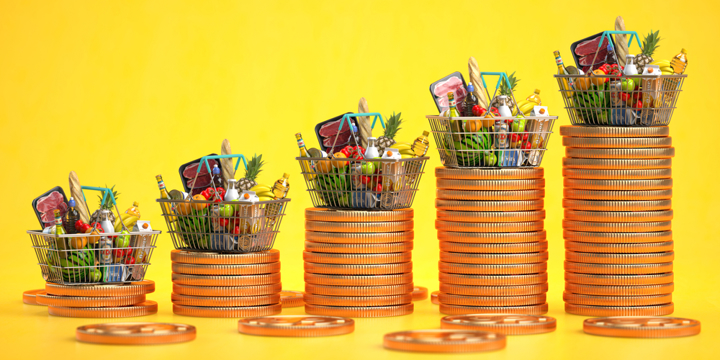 Many gold coins are stacked, and a shopping basket is placed on the top of the coin, which contains various kinds of meat, eggs, milk, vegetables and other foods