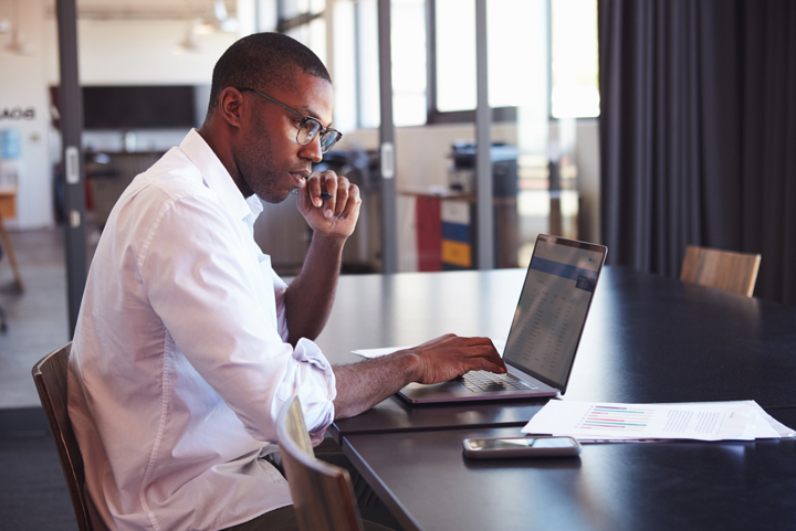 Man prepares for a meeting on computer